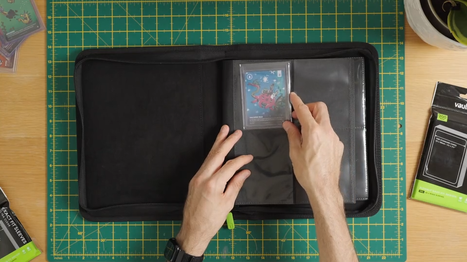 Load video: A video showing a trading card being put into a Vault X soft sleeve, into a toploader, into a toploader sleeve and into a Vault X Toploader compatible binder.